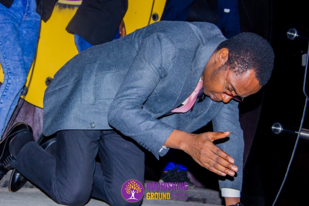 Pastor kneeling to pray